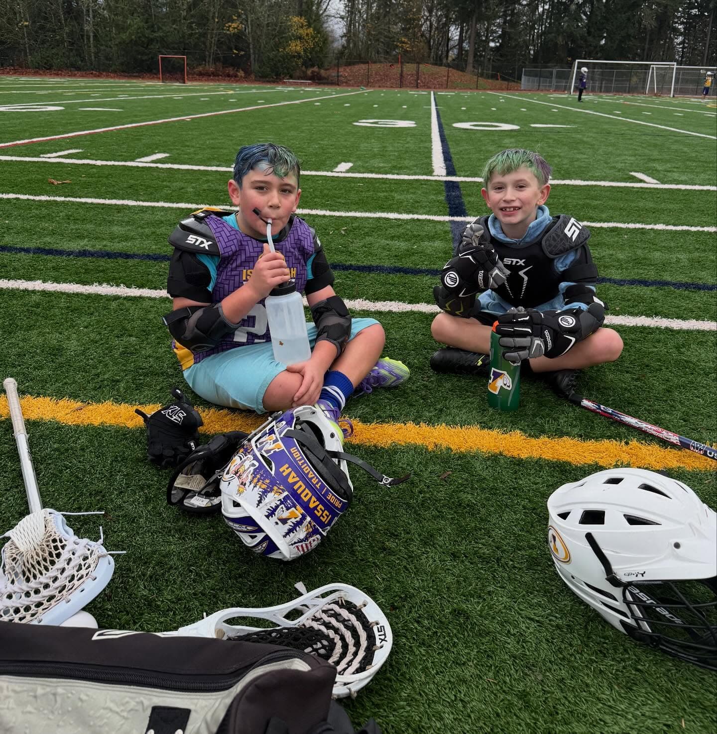 Two players taking a water break together at the club’s 2025 Bring-a-Friend practice.